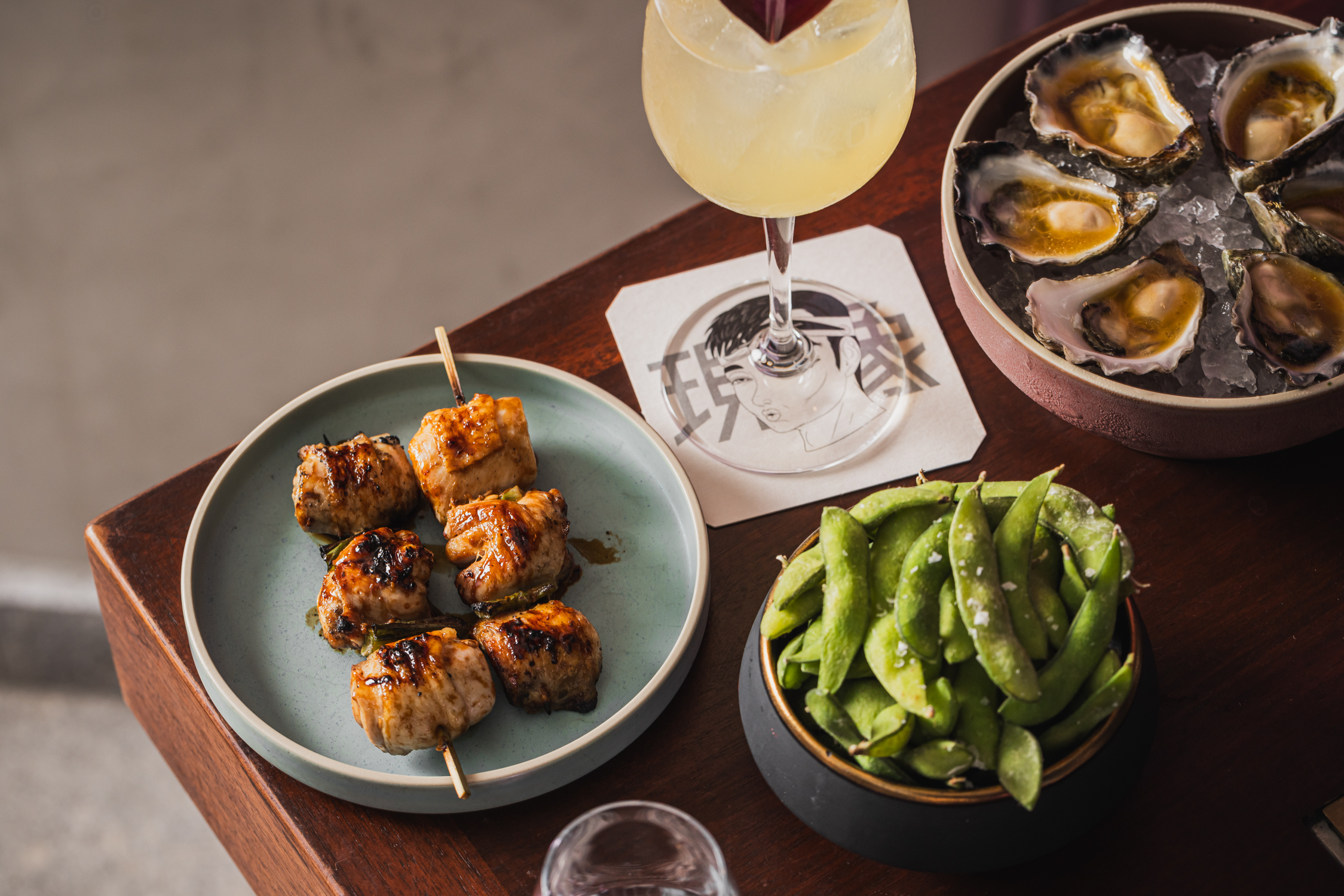 chicken skewers with cocktail and edamame beans