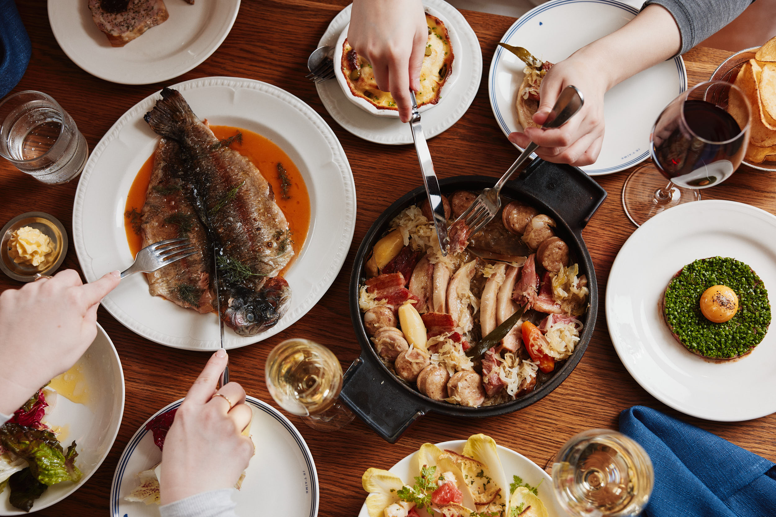 group dining table french food with hands