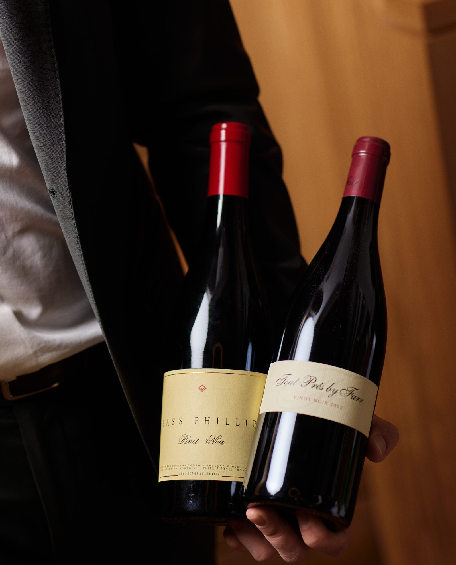 TheCharles_September_StevenWoodburn_96 sommeliar holding two bottles of wine